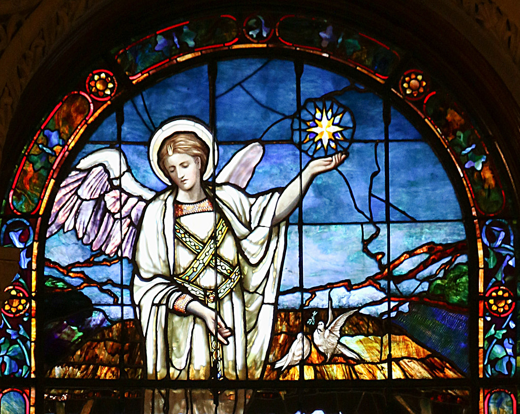 A stained glass window depicting an angel and the Star of Bethlehem 