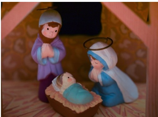 A picture of three dolls depicting the nativity scene 