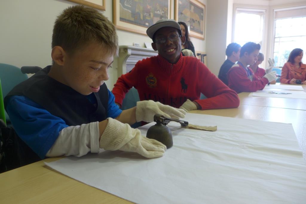 Students exploring a museum object