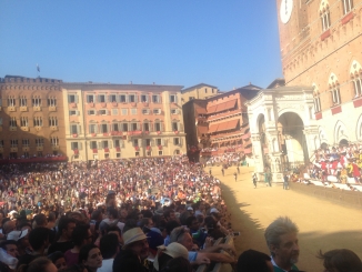  Palio Day in the Piazza del Campo, which is ram-packed with spectators waiting for the horse race to commence. The build up to this 3-minute long race is electrifying. 