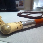 The engraved ferrule on the hunting whip.