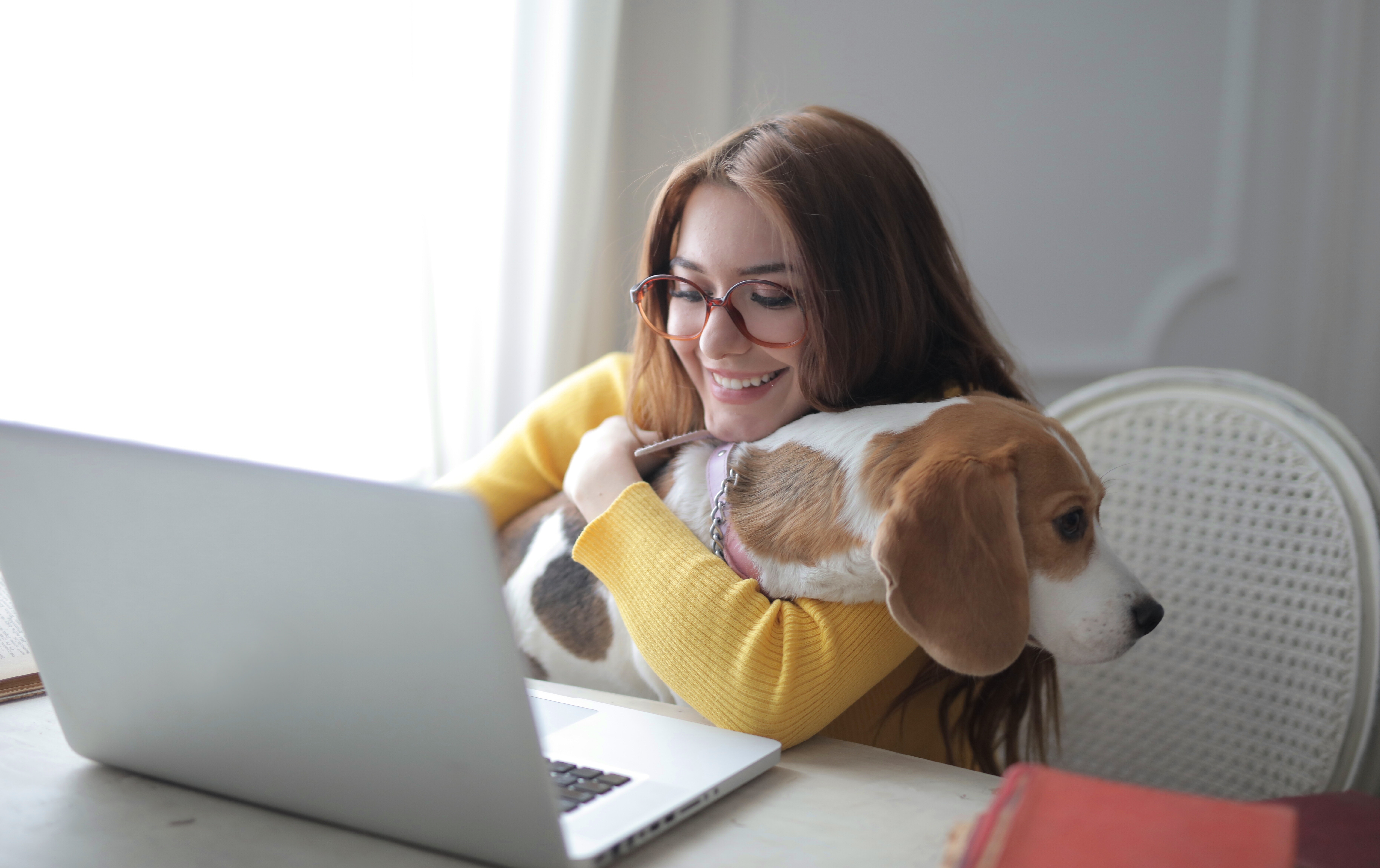 women working at home, hugging dog
