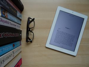 Books, glasses and a tablet