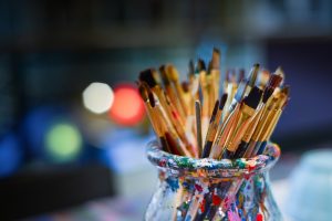 Paint brushes in a glass jar