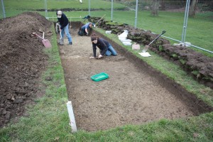 Cleaning back the trench to show the features