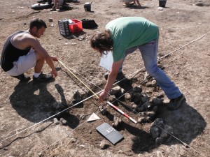 Alex and Andy record in plan the pit containing extensive iron smelting material