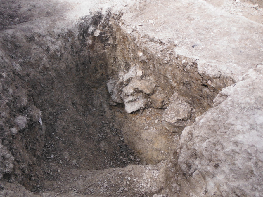 The substantial post-pit half-sectioned, with the flint packing for a very large post clearly visible