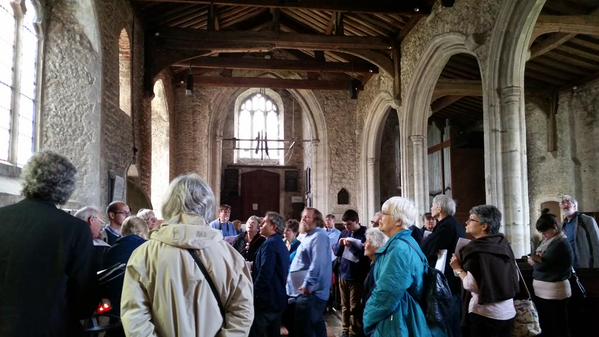 Delegates to the conference were taken on a tour of Lyminge, here learning about the church. Photo by Carolyn Twomey.