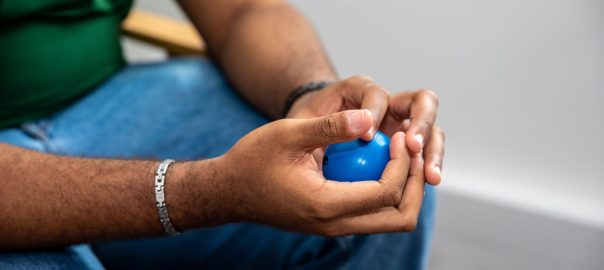 Student holding a blue stress ball whilst using the student support services