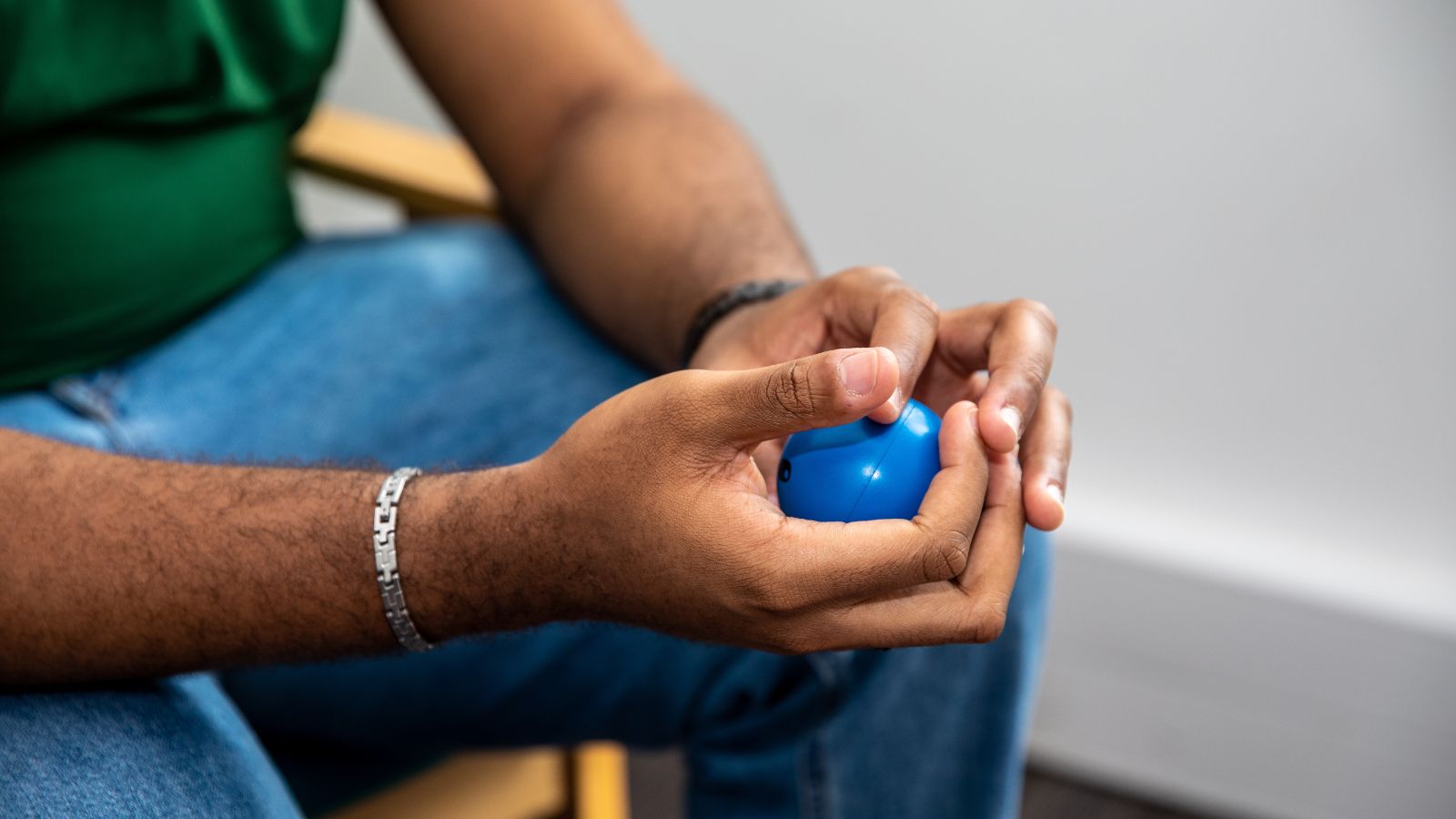 Student holding a blue stress ball whilst using the student support services