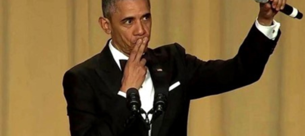 barack obama holding a mic at a podium