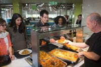 students getting food in a cafeteria