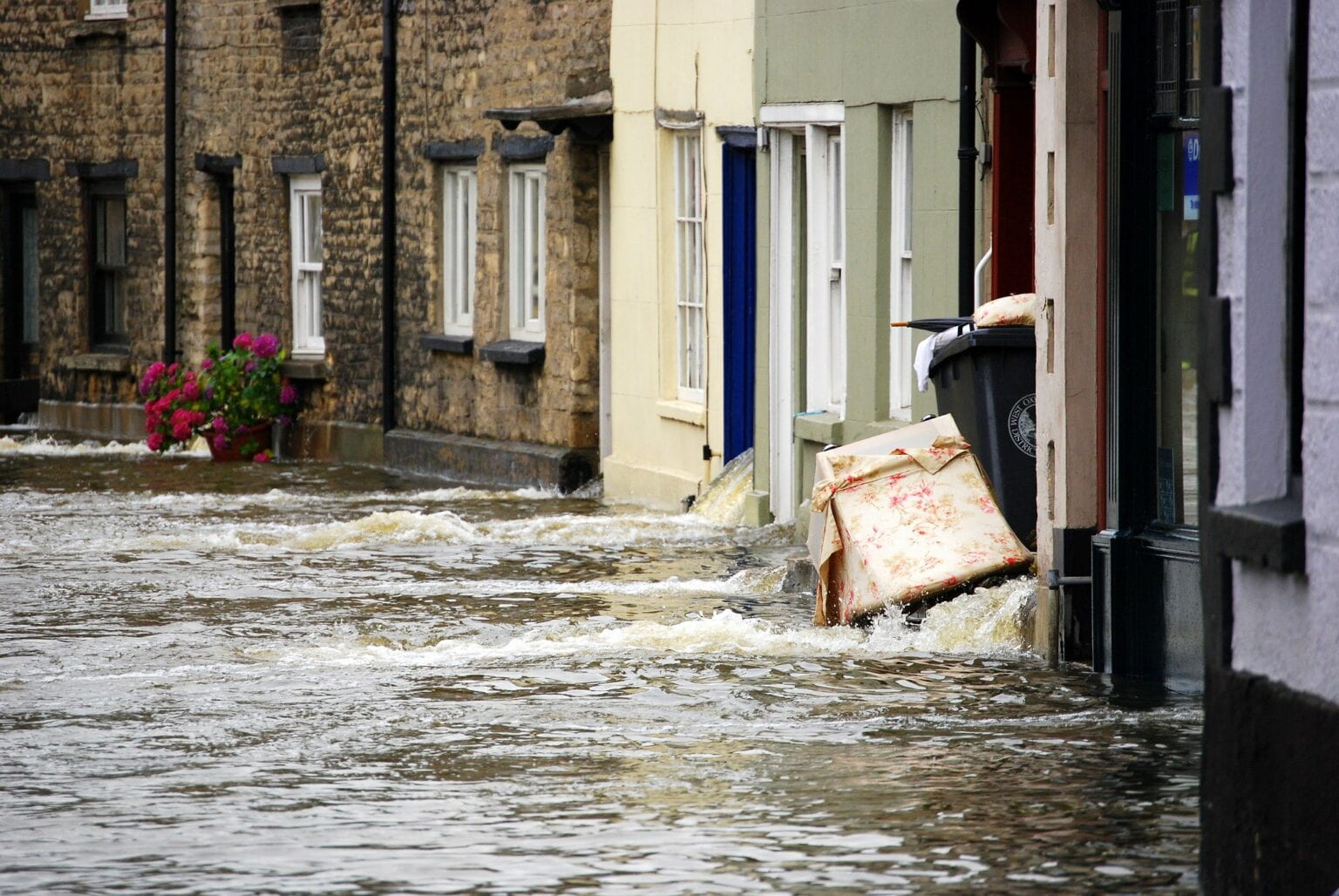 Flooding on a street in Whitley; Image via dachalan on Flickr (CC BY-NC-SA 2.0).